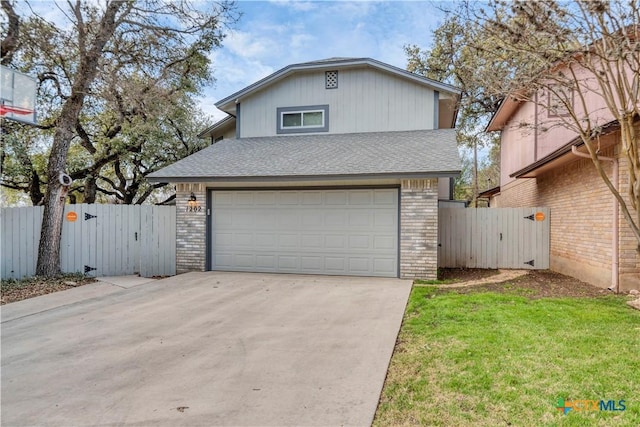 view of front of property with brick siding, fence, a garage, and a gate