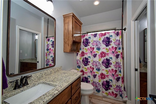 bathroom featuring recessed lighting, a shower with shower curtain, toilet, and vanity