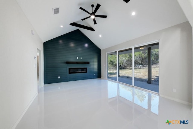 unfurnished living room with ceiling fan, a large fireplace, light tile patterned floors, and high vaulted ceiling