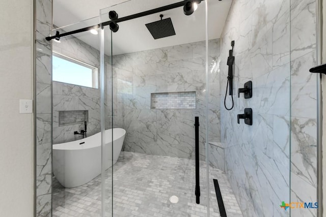 bathroom featuring shower with separate bathtub