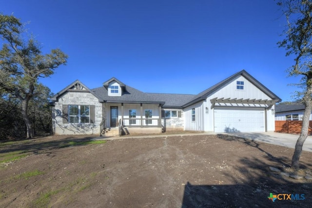 view of front of property featuring a porch and a garage