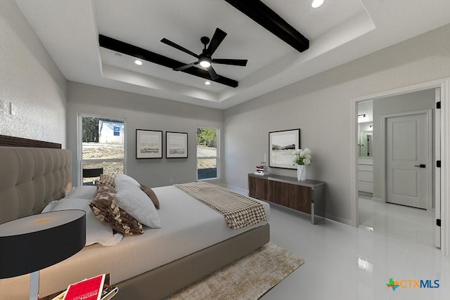 bedroom featuring ceiling fan, beam ceiling, a raised ceiling, and connected bathroom