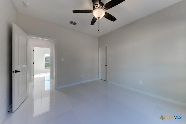 tiled empty room with ceiling fan