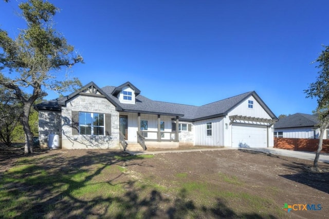 view of front of home featuring covered porch and a garage