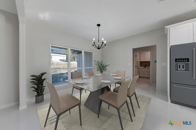 dining space featuring an inviting chandelier