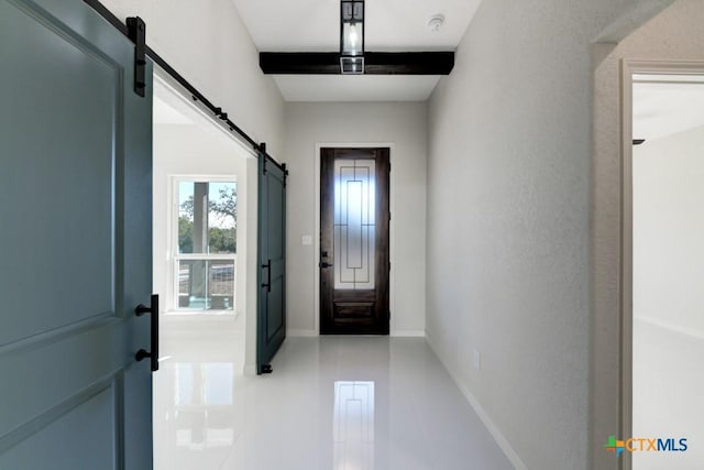 entryway with a barn door and tile patterned floors