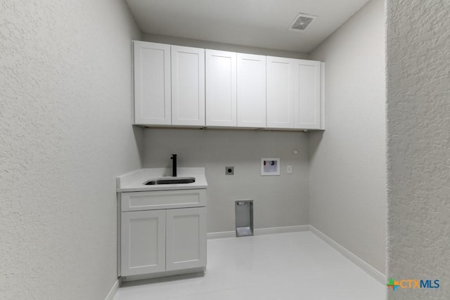 clothes washing area with washer hookup, electric dryer hookup, cabinets, and sink