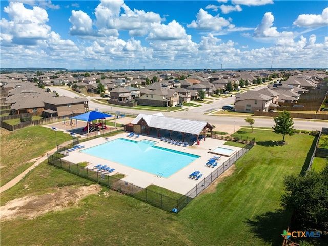 view of swimming pool featuring a patio and a yard