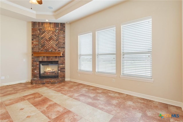 2747 Hester Way, Salado, TX 76571 - unfurnished living room with a fireplace, a tray ceiling, ornamental molding, a ceiling fan, and baseboards