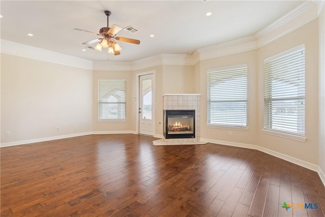 2747 Hester Way, Salado, TX 76571 - unfurnished living room with ceiling fan, dark wood-style flooring, a tiled fireplace, ornamental molding, and baseboards