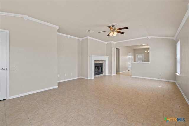 711 Leo Ln, Killeen, TX 76542 - unfurnished living room featuring a ceiling fan, crown molding, a tile fireplace, and arched walkways