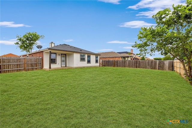 711 Leo Ln, Killeen, TX 76542 - rear view of property featuring a fenced backyard and a chimney