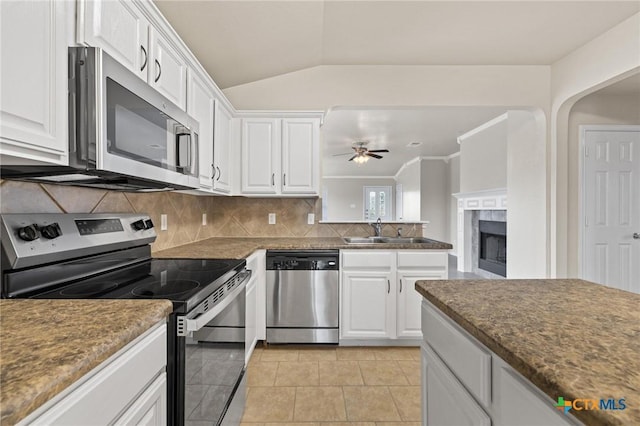 711 Leo Ln, Killeen, TX 76542 - kitchen featuring appliances with stainless steel finishes, ceiling fan, white cabinets, decorative backsplash, and light tile patterned flooring