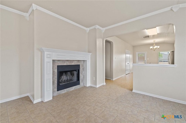 711 Leo Ln, Killeen, TX 76542 - unfurnished living room featuring arched walkways, a chandelier, a tile fireplace, crown molding, and light tile patterned floors