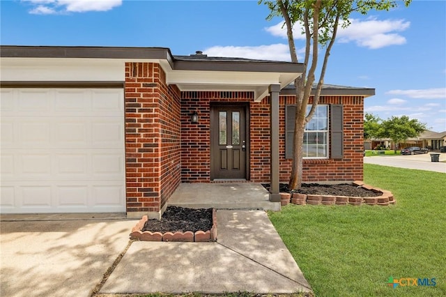 711 Leo Ln, Killeen, TX 76542 - entrance to property featuring brick siding, a garage, a lawn, and concrete driveway