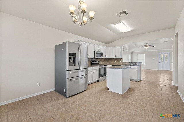 711 Leo Ln, Killeen, TX 76542 - kitchen with stainless steel appliances, vaulted ceiling, white cabinets, decorative backsplash, and a chandelier