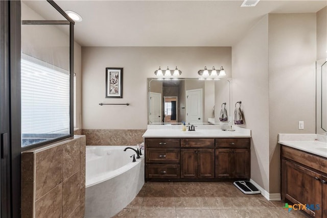3308 Ten Bits Dr, Belton, TX 76513 - full bath with plenty of natural light, two vanities, and a garden tub
