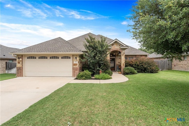 3308 Ten Bits Dr, Belton, TX 76513 - french provincial home featuring an attached garage, brick siding, driveway, and a shingled roof