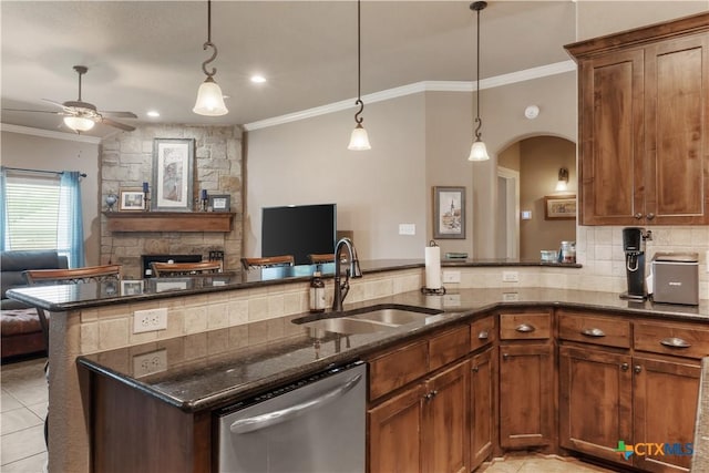 3308 Ten Bits Dr, Belton, TX 76513 - kitchen with stainless steel dishwasher, a sink, open floor plan, ornamental molding, and dark stone countertops