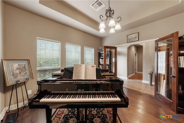 3308 Ten Bits Dr, Belton, TX 76513 - living area with a chandelier, baseboards, wood finished floors, and a raised ceiling