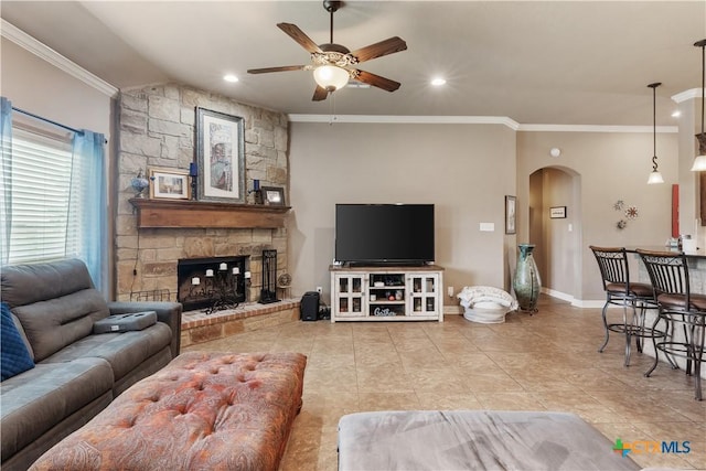 3308 Ten Bits Dr, Belton, TX 76513 - living area featuring arched walkways, a ceiling fan, tile patterned flooring, crown molding, and a fireplace