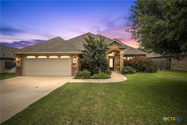 3308 Ten Bits Dr, Belton, TX 76513 - view of front facade featuring driveway, an attached garage, brick siding, and roof with shingles