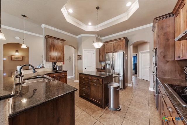 3308 Ten Bits Dr, Belton, TX 76513 - kitchen featuring arched walkways, appliances with stainless steel finishes, a sink, a center island, and ornamental molding