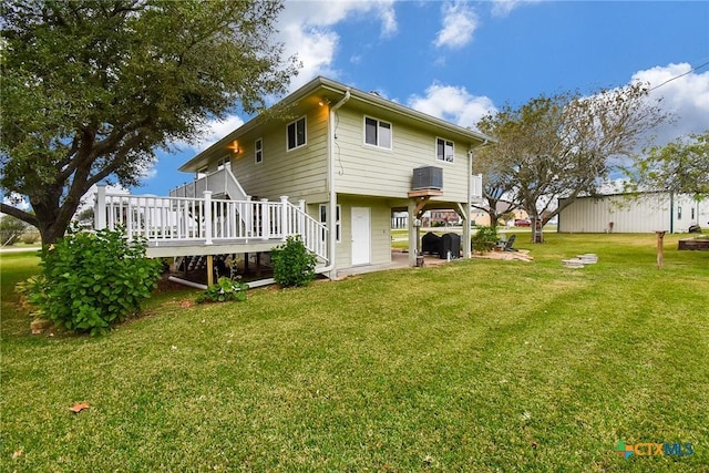 back of house featuring a deck and a yard