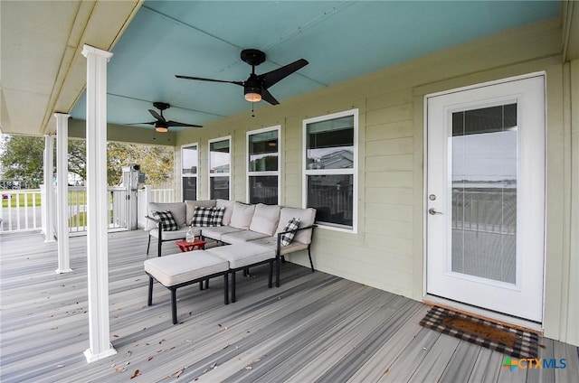 wooden deck featuring a porch and an outdoor hangout area