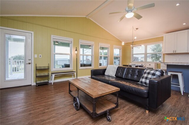 living room with ceiling fan, dark wood-type flooring, and vaulted ceiling