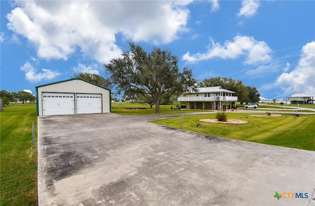 view of front facade with a front yard, a garage, and an outdoor structure