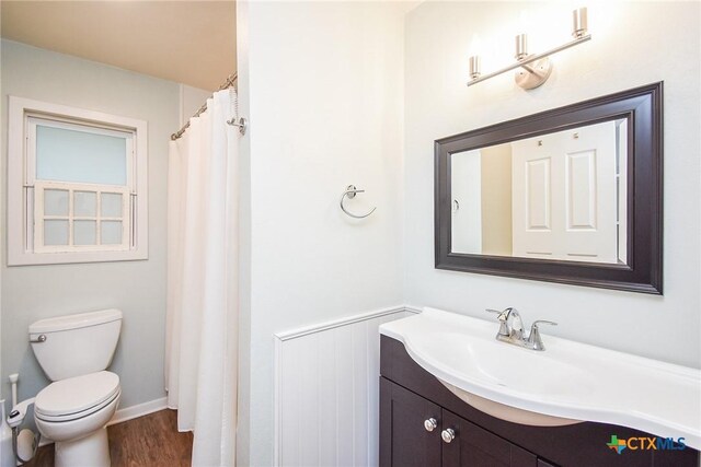 bathroom featuring vanity, toilet, and wood-type flooring