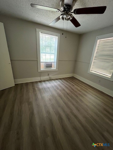 spare room featuring a textured ceiling, dark hardwood / wood-style floors, ceiling fan, and cooling unit