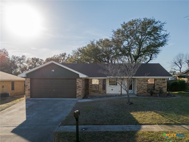 ranch-style house with a garage, brick siding, driveway, and a front lawn