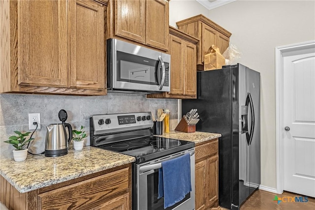 1703 Fossil Trl, Belton, TX 76513 - kitchen featuring light stone countertops, brown cabinetry, stainless steel appliances, tasteful backsplash, and ornamental molding