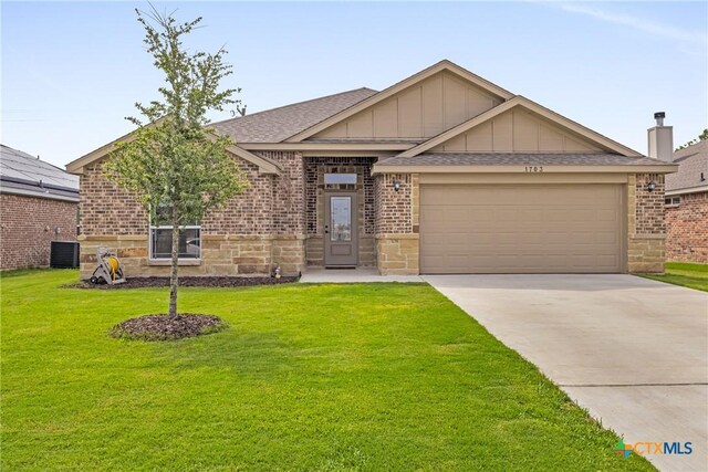 single story home featuring a garage and a front yard