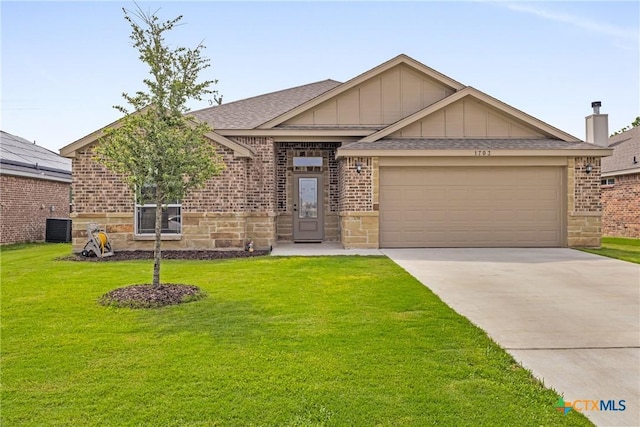 1703 Fossil Trl, Belton, TX 76513 - ranch-style home with an attached garage, a front lawn, brick siding, board and batten siding, and driveway