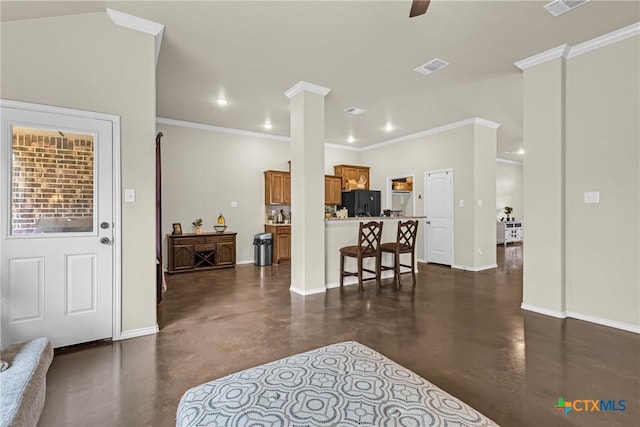 1703 Fossil Trl, Belton, TX 76513 - living area featuring baseboards, ornamental molding, and concrete floors