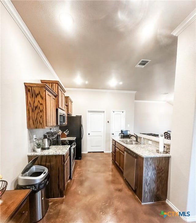 kitchen with appliances with stainless steel finishes, sink, decorative backsplash, ornamental molding, and light stone counters