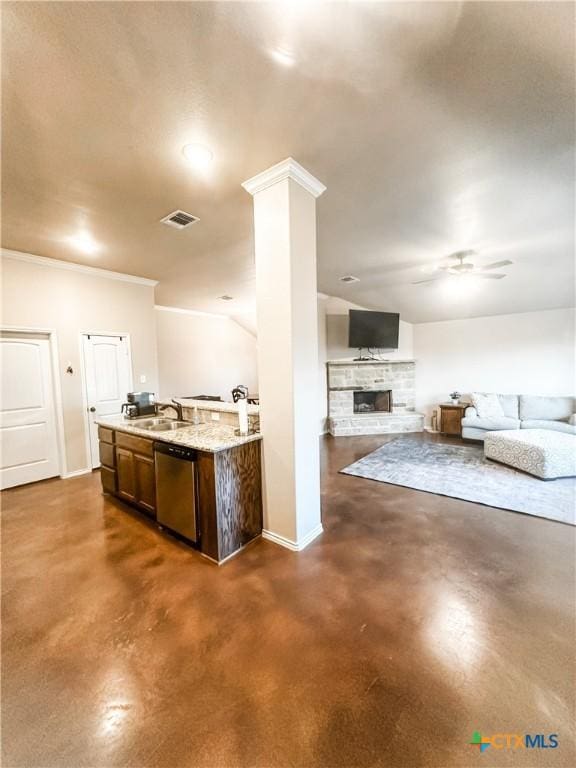 kitchen featuring a fireplace, decorative columns, sink, stainless steel dishwasher, and ceiling fan