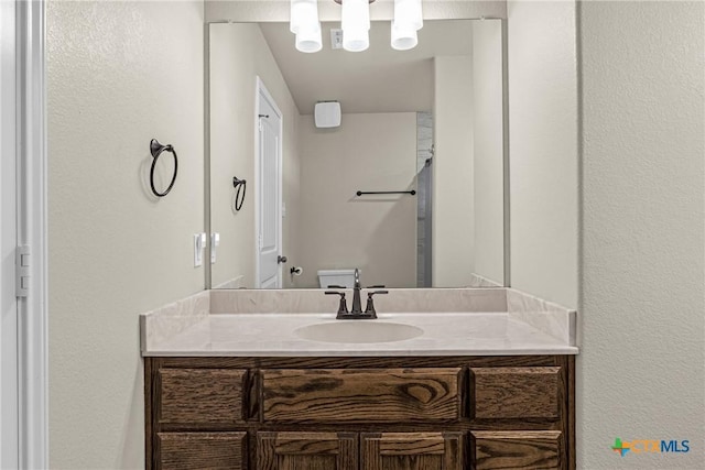 1703 Fossil Trl, Belton, TX 76513 - bathroom with a textured wall, an inviting chandelier, and vanity