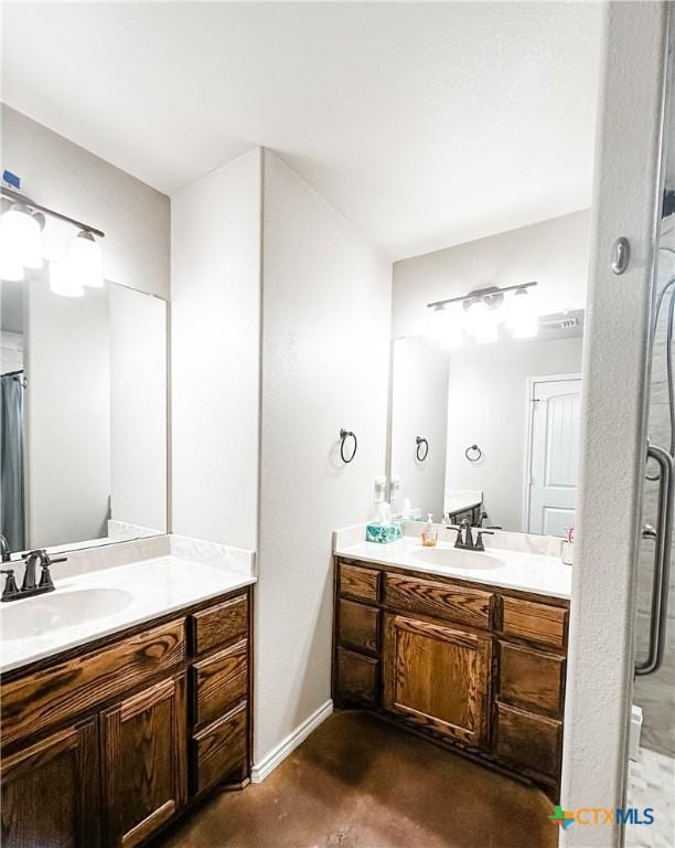 bathroom featuring walk in shower, vanity, and concrete flooring