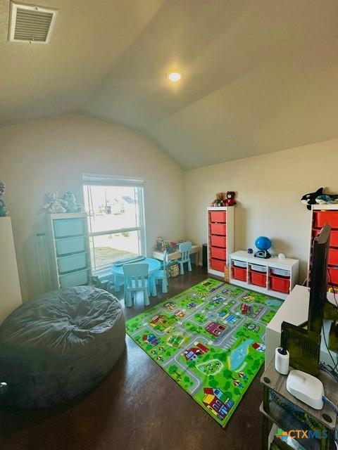 game room with vaulted ceiling