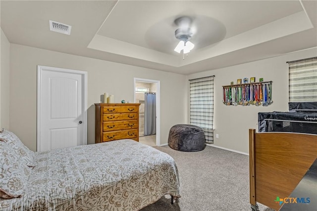 1703 Fossil Trl, Belton, TX 76513 - carpeted bedroom with a tray ceiling and a ceiling fan