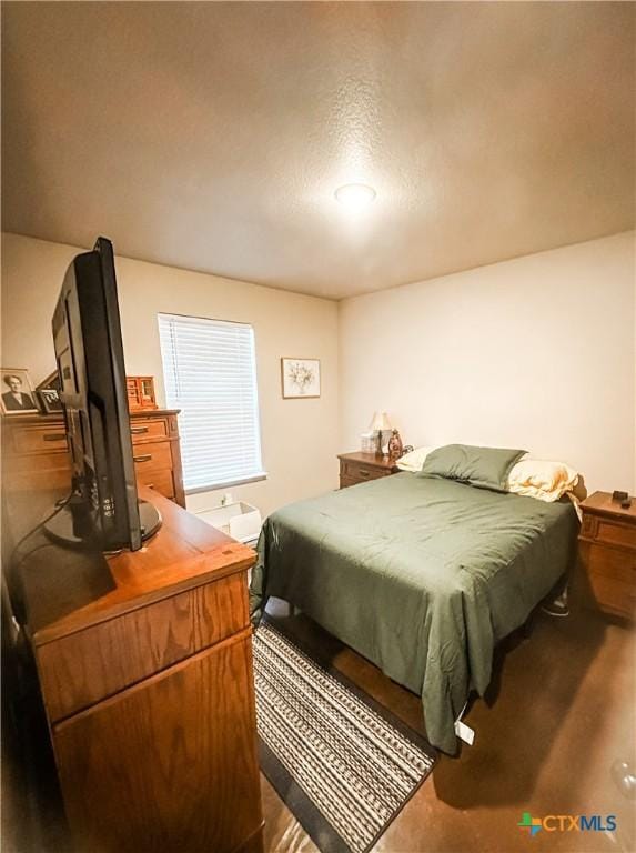 bedroom with hardwood / wood-style floors