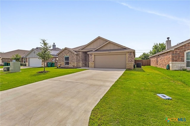 1703 Fossil Trl, Belton, TX 76513 - single story home featuring brick siding, a front lawn, board and batten siding, and driveway