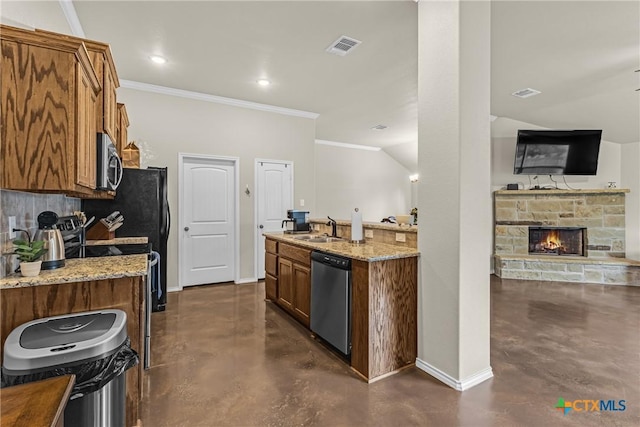 1703 Fossil Trl, Belton, TX 76513 - kitchen featuring concrete flooring, stainless steel appliances, brown cabinets, and light stone counters