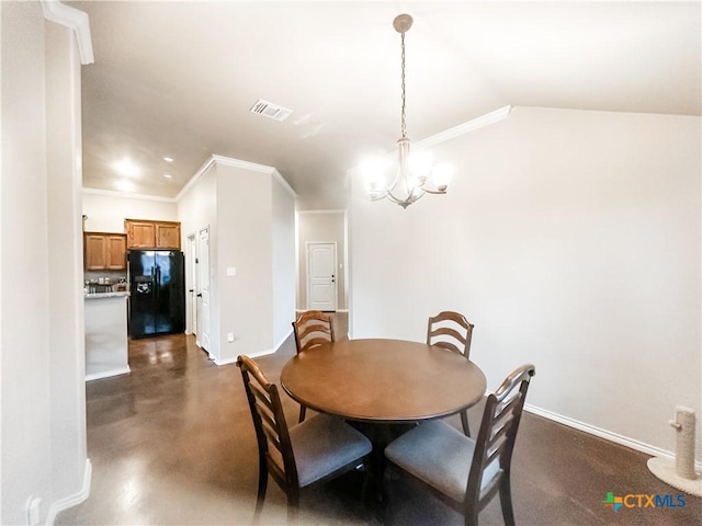 dining space featuring ornamental molding, vaulted ceiling, and a notable chandelier