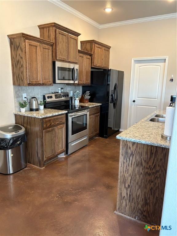 kitchen featuring crown molding, light stone countertops, decorative backsplash, and stainless steel appliances