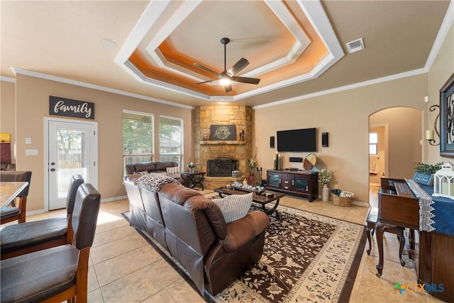 3201 Purple Sage Dr, Belton, TX 76513 - living area with ceiling fan, a raised ceiling, arched walkways, light tile patterned floors, and visible vents